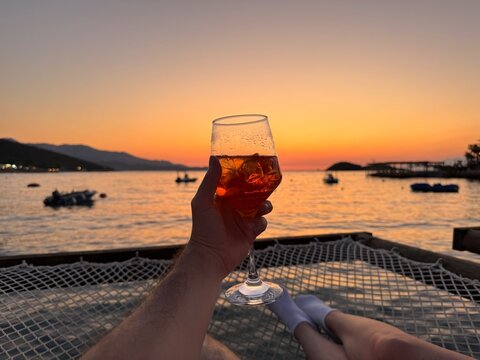 Couple enjoying sunset cocktails on the water net on Albanian Riviera