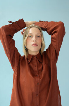 Fashion Portrait of Blonde Woman in Oversized Terracotta Shirt 