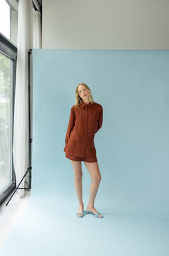 Fashion Portrait of Blonde Woman in Oversized Terracotta Shirt 