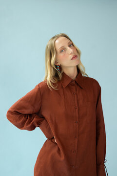 Fashion Portrait of Blonde Woman in Oversized Terracotta Shirt 
