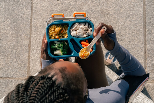 Enjoying a Lunch Box Meal at a Public Space in the Daytime