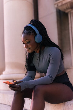 Jogger using smartphone outdoors 