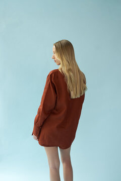 Side Profile Portrait of Blonde Female Model in Terracotta Shirt 