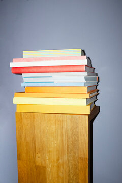 Contemporary book pile on a pedestal in work business office