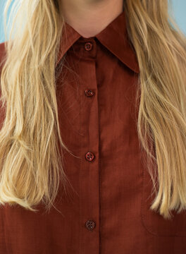 Close-up Studio Portrait of Blonde Model in Terracotta Shirt 