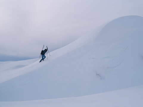 Backcountry Ski Explorer Ascending Steep Mountain Ridge