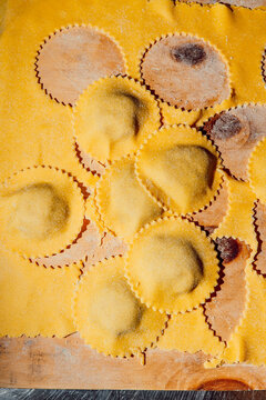 Fresh homemade ravioli pasta on a wooden board