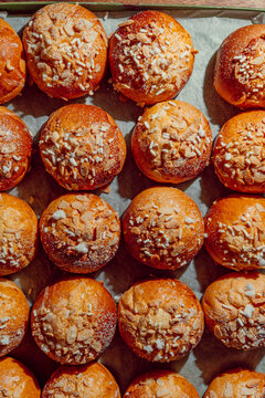 Rows of fresh sweet brioche pastries with pearl sugar