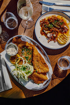 Mediterranean restaurant table with meat milanesa and grilled octopus