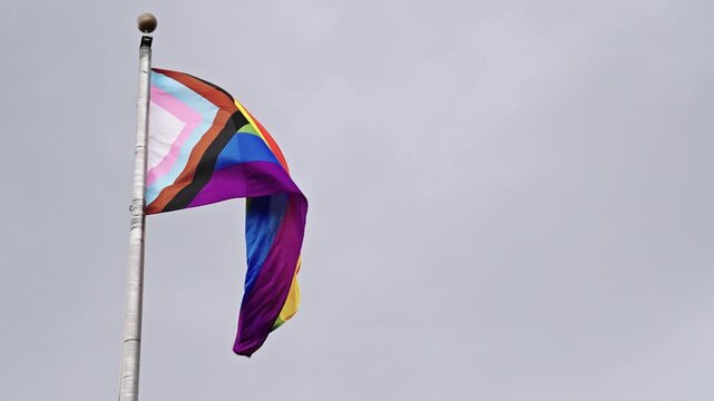 LGBT community. Tolerance and equality. World gay pride. Rainbow gay flag. Pride month. LGBTQ rainbow flag. LGBT rainbow flag waving against sky. Symbol of pride and LGBTQ. Colorful pride flag
