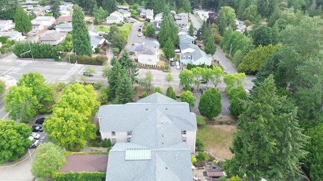 Covered entry porticos line Pete von Reichbauer Way South, seamlessly connecting multi story residential complexes to surrounding pine forests in Federal Way, suburbs Seattle, Washington