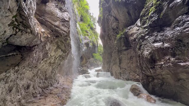 Partnachklamm gorge. Mountain river surrounded by a steep cliff. Popular tourists attraction and hiking area. Garmisch Partenkirchen, Germany