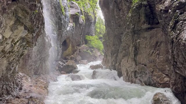 Partnachklamm gorge. Mountain river surrounded by a steep cliff. Popular tourists attraction and hiking area. Garmisch Partenkirchen, Germany