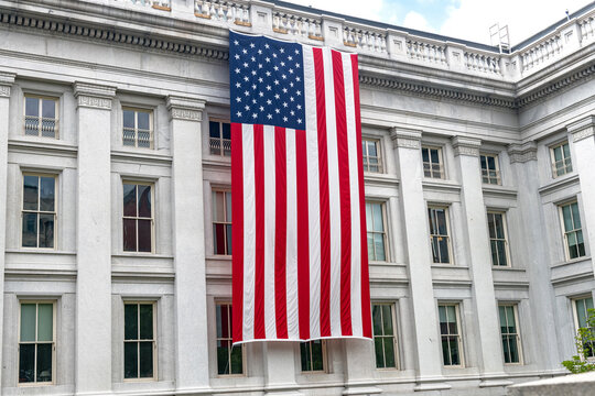 Treasury Department facade and American flag define this Washington DC government landmark.