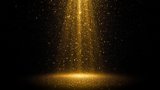 Golden glitter dust falling on a black background dramatic illumination