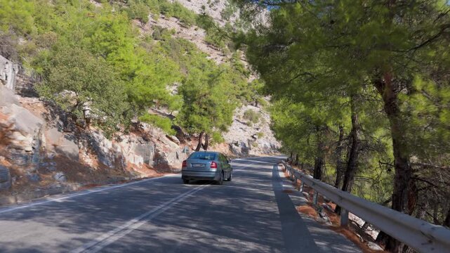 THASSOS, GREECE - SEPTEMBER 12, 2025: Traffic and car overtaking on the scenic winding roads of Mount Ipsarion