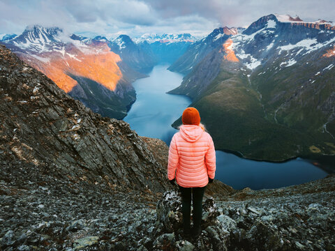 Woman traveler hiking in Norway travel solo active vacations girl tourist enjoying aerial lake view and sunset mountains, healthy lifestyle tour explore offbeat trails in Romsdal harmony with nature