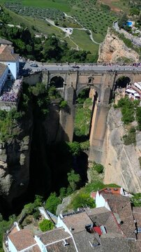 Ronda aerial vertical view - the famous Puente Nuevo Bridge over the El Tajo gorge, a historic town on the edge of a rocky gorge