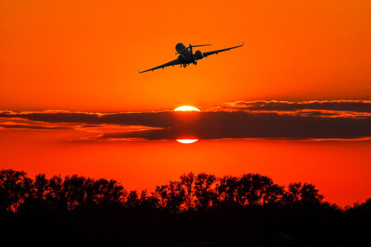 Bizjet take off against the backdrop of crimson sunrise