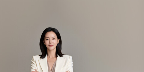 Obraz premium single refined korean woman in tailored ivory suit with calm trustworthy expression, elegant asian businesswoman portrait with natural beauty and premium aesthetic style