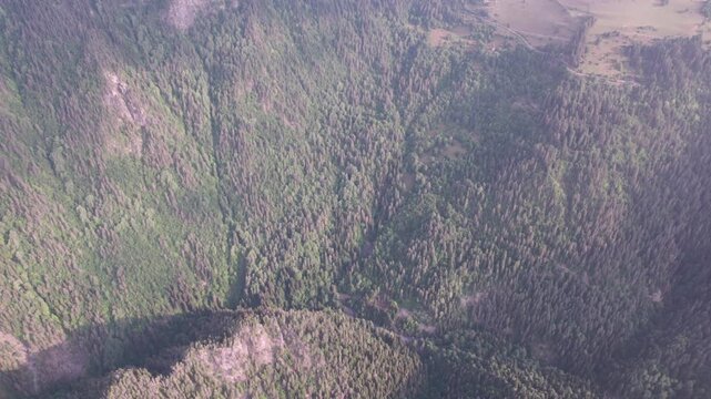 Cinematic drone flight above lush green Caucasus mountains, drifting clouds in Svaneti, Georgia. Peaceful aerial landscape for travel films, meditation, relaxation, wellness nature projects