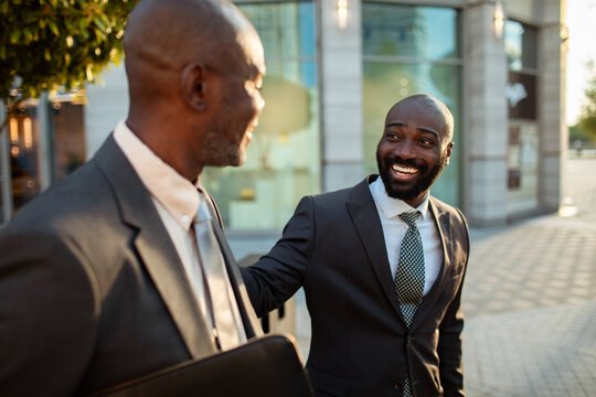Two business colleagues greeting outside office building