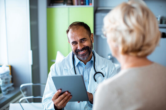 Smiling doctor consulting senior patient in clinic