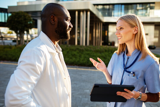 Medical professionals discussing patient care outside hospital