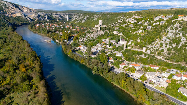 Aerial view of Pocitelj historic village with stone houses, minaret, and fortress ruins overlooking the Neretva River, Pocitelj, Federation of Bosnia, Bosnia and Herzegovina.