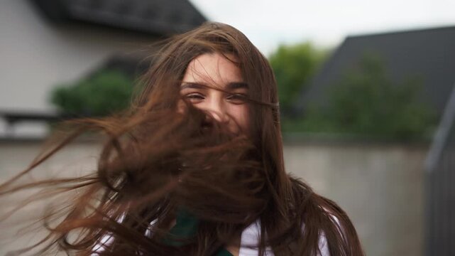 Sensual businesswoman looking at camera with long hair flying in the wind close up shot