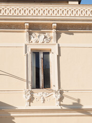 Art Nouveau Liberty building facade with ornate stucco window surround, dragon relief and decorative frieze, Olbia, Sardinia © Inna