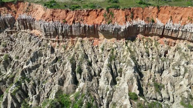 Aerial view of colorful layered rock formations in a canyon