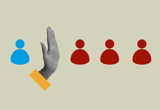 Raised hand separating one person from a group for social exclusion concept.