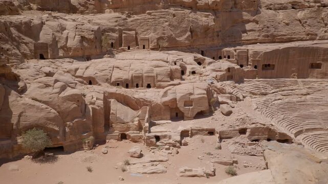 Ancient rock-cut tombs and dwellings in desert landscape