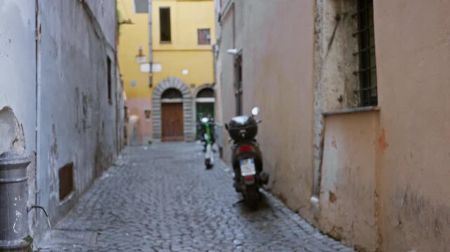 Rome cobblestone alley with parked scooters and faded plaster walls, softly defocused bokeh background street; background backplate copyspace template calm.