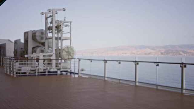 Cruise deck scene with defocused railing and distant sea, soft bokeh outdoor; background backdrop copyspace.