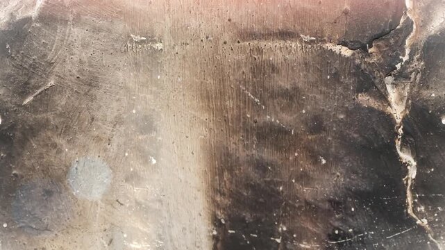 Seamless 4K looping vertical movement across a dark cracked stone surface with dramatic weathered texture. Suitable for grunge backgrounds cinematic visuals and industrial projects.