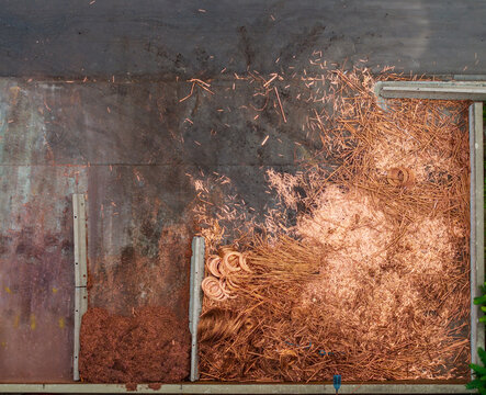 Aerial view of copper scrap and metal wire piles in an industrial yard at the Serravalle Logistic area in Serravalle Scrivia, Piedmont, Italy.