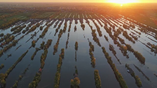 Aerial sunset view flying over scheendijk lake in breukelen