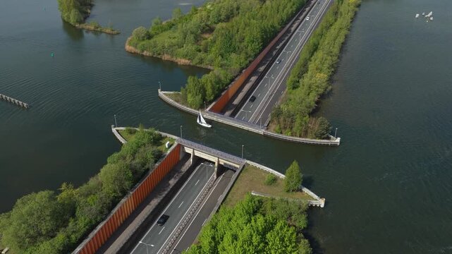 Sailboat crossing over veluwemeer aqueduct highway traffic