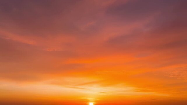 Slow motion waves of warm orange and red sunset sky timelapse
