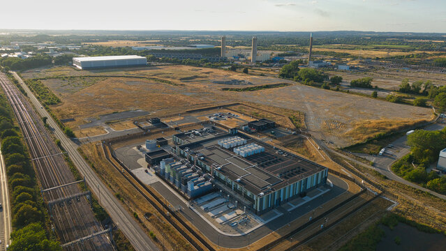 Aerial view of Hyperscale Data Center during golden hour, with cooling units, rooftop equipment, and infrastructure near railway tracks Didcot, England, United Kingdom.