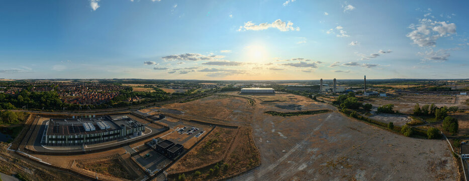 Aerial view of the Hyperscale Data Center during golden hour, featuring modern industrial architecture and surrounding open landscape in Didcot, England, United Kingdom.
