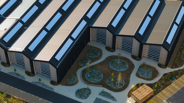 Aerial view of the modern solar roof of Tech Foundry 3 at Harwell Science and Innovation Campus with landscaped courtyards and pathways in Didcot, England, United Kingdom.