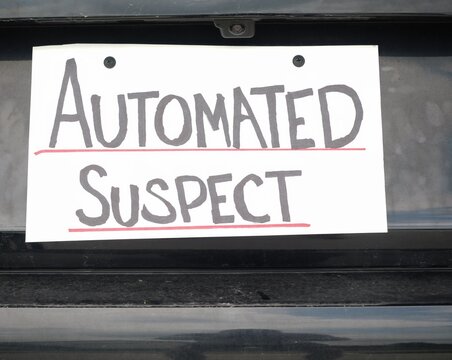 Man attaching protest license plates to vehicle using screwdriver, illustrating citizen pushback against ALPR surveillance - Fourth Amendment privacy