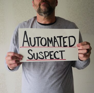 Man attaching protest license plates to vehicle using screwdriver, illustrating citizen pushback against ALPR surveillance - Fourth Amendment privacy