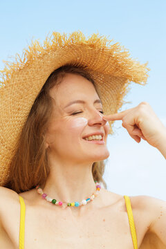 Woman Applying SPF Face Cream For Summer Sun Protection