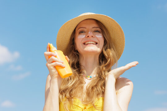 Woman Applying SPF Face Cream For Summer Sun Protection