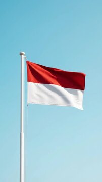 Indonesian Independence Day Flag Waving Against Clear Blue Sky
