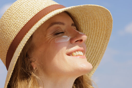 Woman Enjoying Sun With Protective SPF Face Cream On Skin